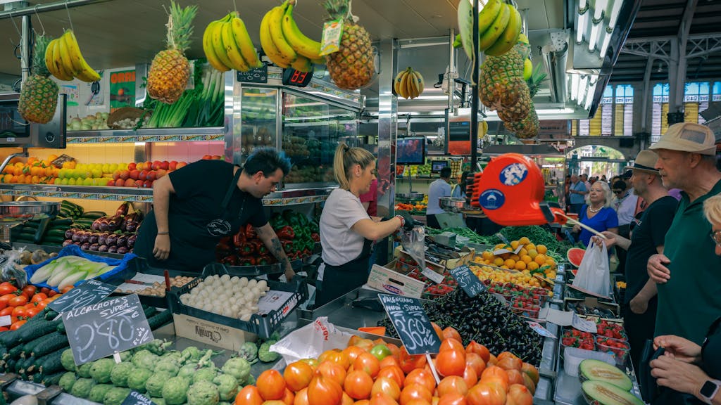 Busy marketplace in Valencia with diverse fruits and vegetables.